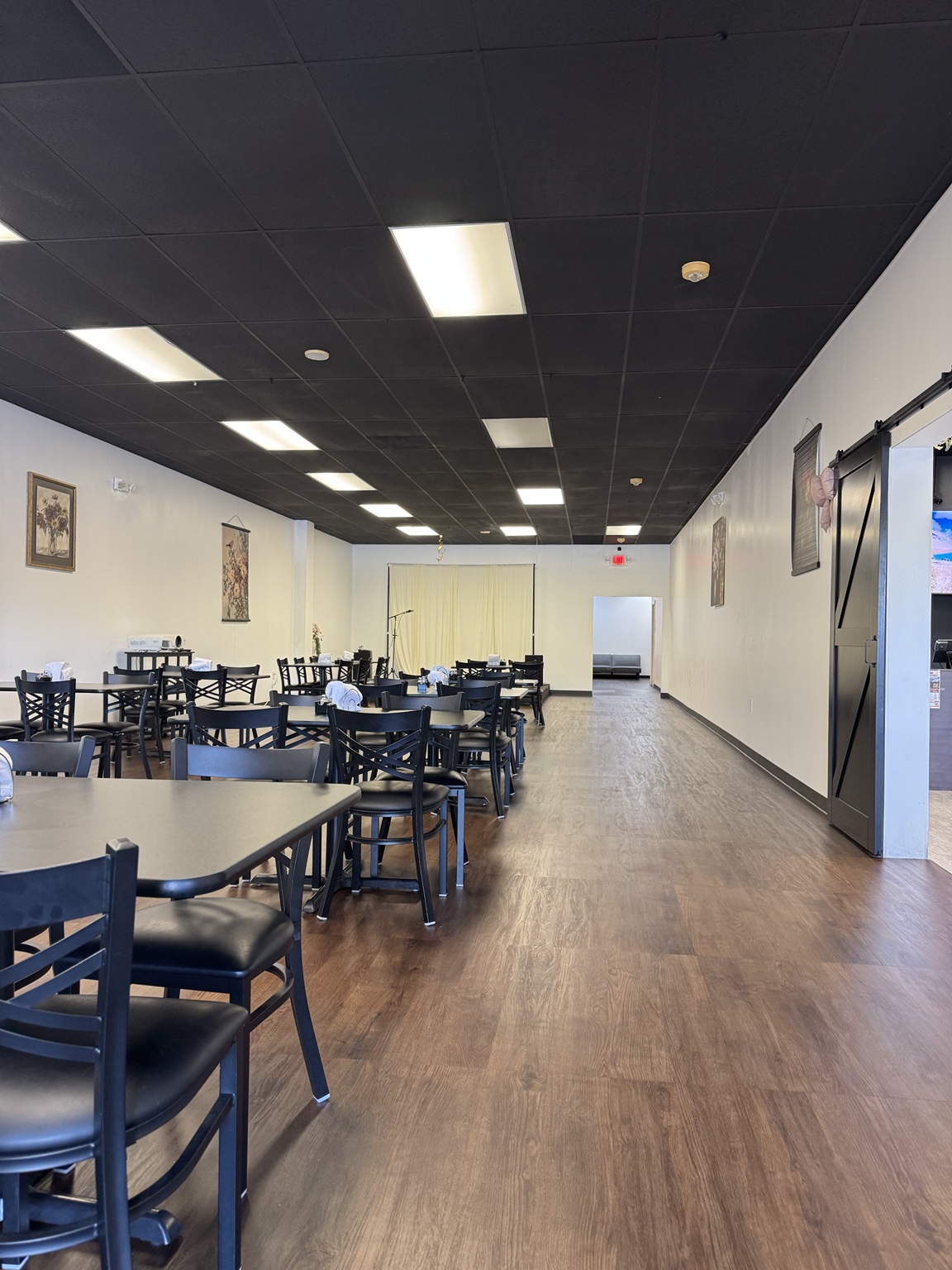 LAKI event room with dining tables and an open floor area